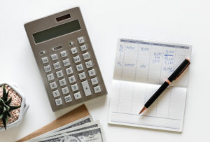 calculator, checkbook, and pen