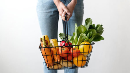 woman carrying basket of groceries